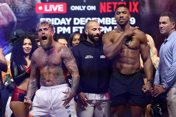 Anthony Joshua Towers Over Jake Paul At Weigh-In, Pain May Be Ahead For YouTuber