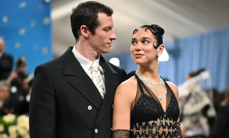 Dua Lipa cuddles with fiance Callum Turner for the holidays. See the pics.