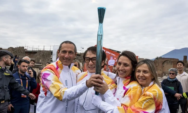 Jackie Chan carries the Olympic torch through the ancient ruins of Pompeii
