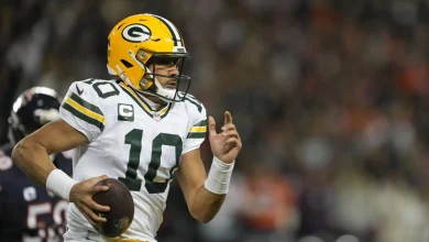 Jordan Love leaves game for training room after taking an illegal hit