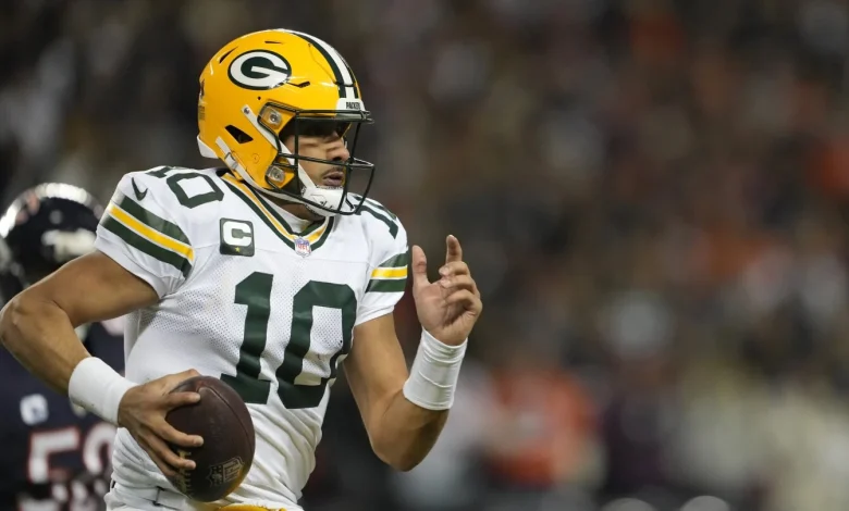 Jordan Love leaves game for training room after taking an illegal hit