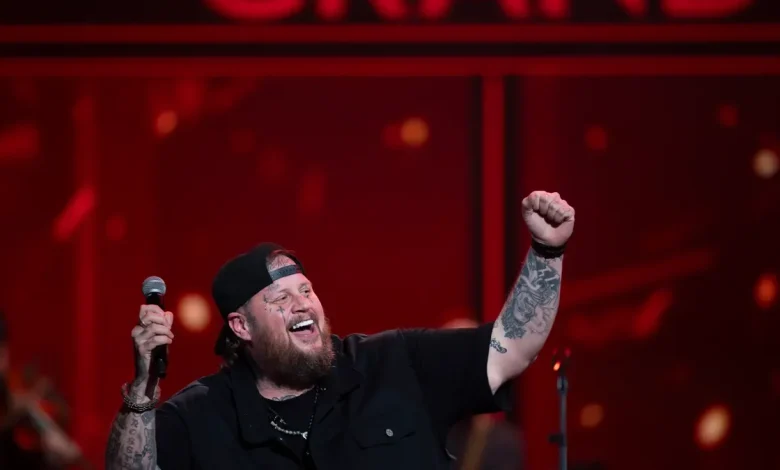 Watch Jelly Roll tearfully accept Opry invite from Craig Morgan