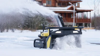 Man Clears Driveway With Autonomous Snow Blower During Storm