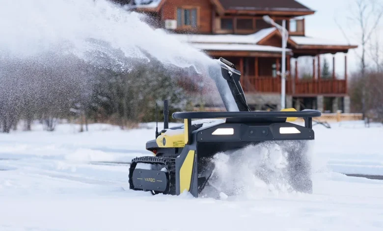 Man Clears Driveway With Autonomous Snow Blower During Storm