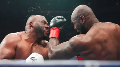 Boxer Jarrell Miller has hairpiece knocked upward by a punch, then throws it into the crowd