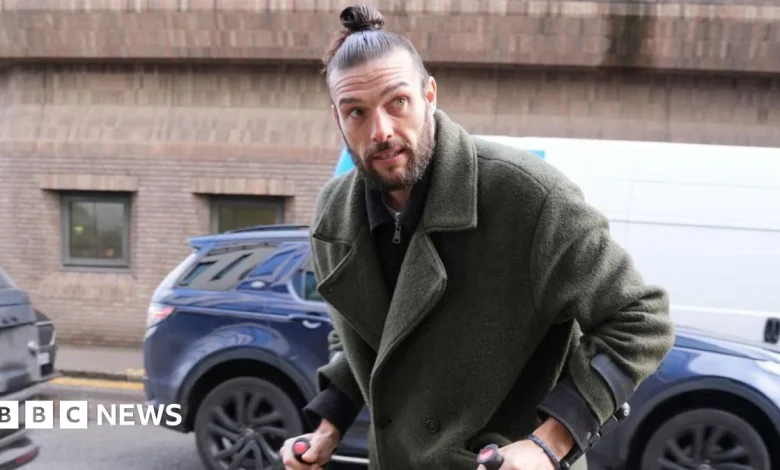 Ex-England striker Carroll denies breach of non-molestation order