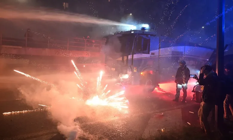 Fireworks fly as hooded protesters clash with police after Olympics open in Milan