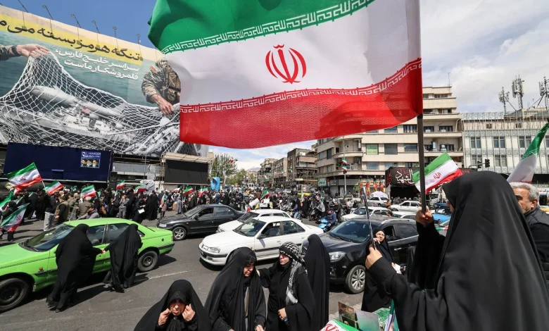 After Trump pauses war, Iranians fly flags of victory not surrender