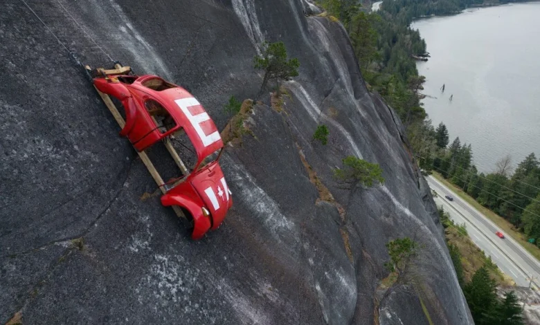 Car shell suspended on rock face above British Columbia highway in apparent prank