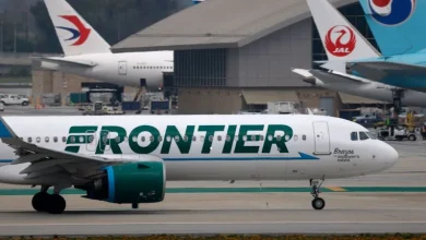Close call at LAX: Frontier Airlines jet slams on the brakes when two trucks cross its path