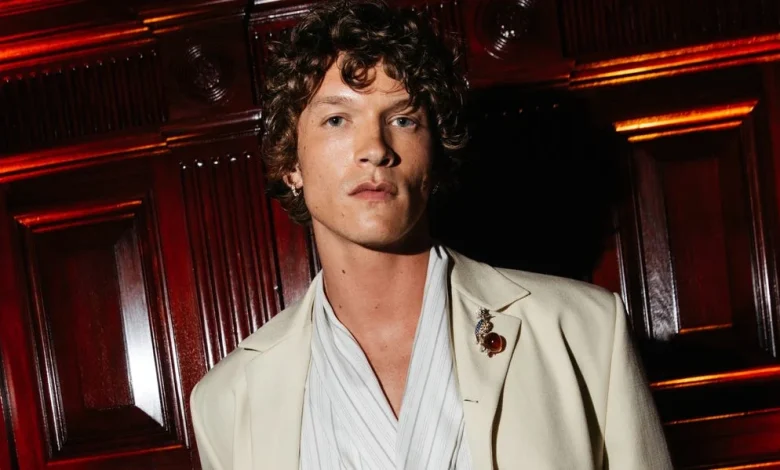 Connor Storrie Is Dapper in a Cream Suit and Wrap Top at the Tiffany Blue Book Gala