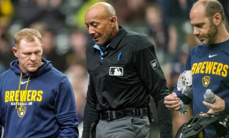 MLB umpire C.B. Bucknor leaves the game after taking foul ball to the face
