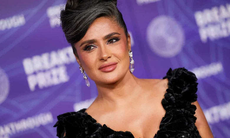 Salma Hayek Embraces Her Natural Gray Hair in a Swooping Updo With a Plunging Sheer LBD