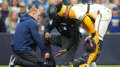 Umpire CB Bucknor leaves game after taking a foul ball off his facemask