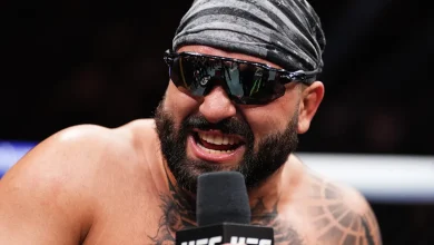 Video: Village idiot sneaks into UFC 327 media day, threatens to ‘cut up’ confused Jiri with plastic sword