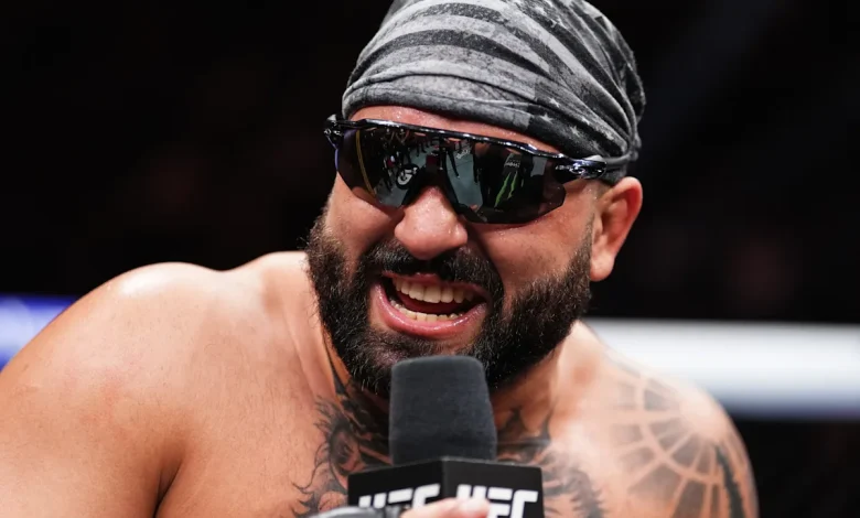 Video: Village idiot sneaks into UFC 327 media day, threatens to ‘cut up’ confused Jiri with plastic sword