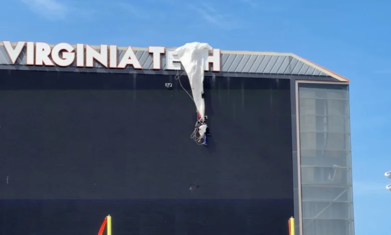 Video shows skydiver rescued after crashing into scoreboard, dangles from parachute at Virginia Tech spring football game