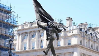 Banksy Stuns With Massive ‘Blind Patriotism’ Statue Stunt In Central London
