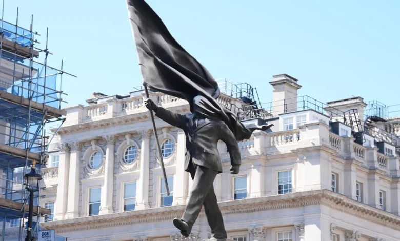 Banksy Stuns With Massive ‘Blind Patriotism’ Statue Stunt In Central London