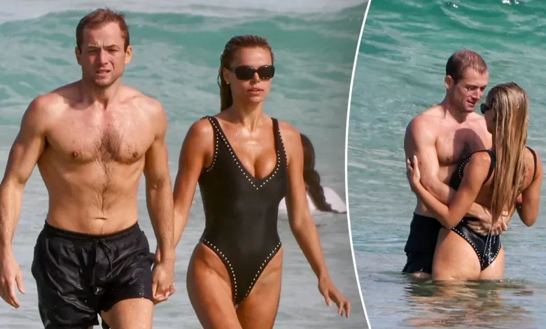 Brooks Nader flaunts plunging swimsuit during steamy beach date with actor Taron Egerton in Australia