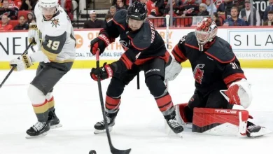 Carolina defenseman Shayne Gostisbehere (4) and goaltender Frederik Andersen (31) defend Vegas right wing Reilly Smith (19) during the first period on Oct. 28, 2025, in Raleigh, N.C.