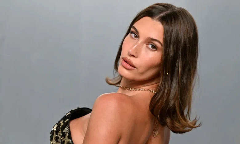Hailey Bieber shows off her curves in a candy pink bikini embracing summer's minimalist swimwear trend