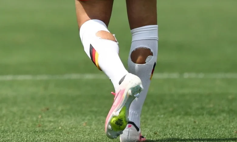 Why are World Cup players cutting holes in their socks?